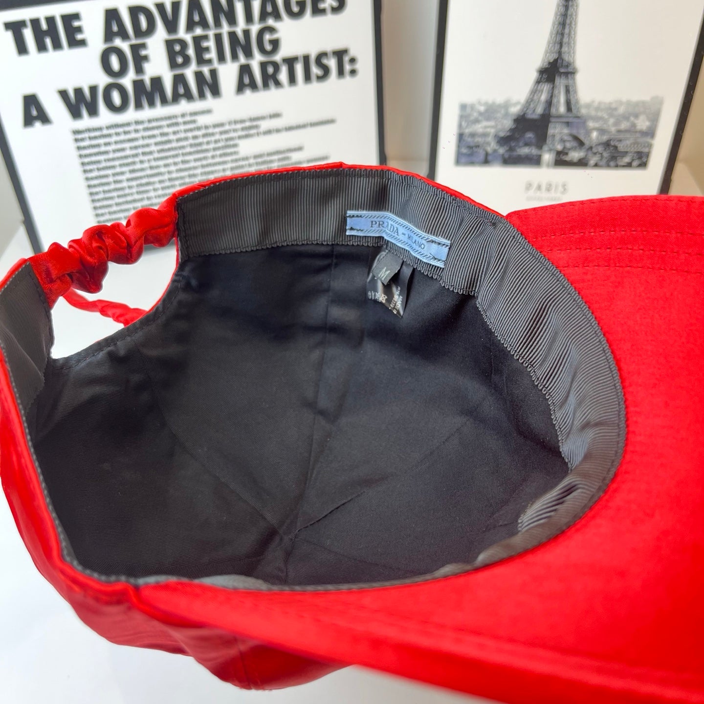 Red cap interior with black lining and blue brand label.