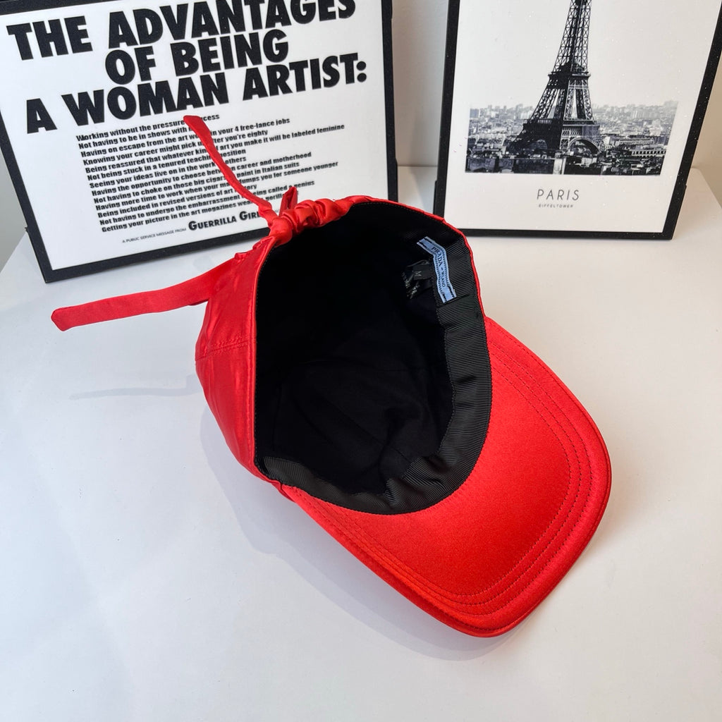 Red cap interior view with black lining and hanging red drawstring.