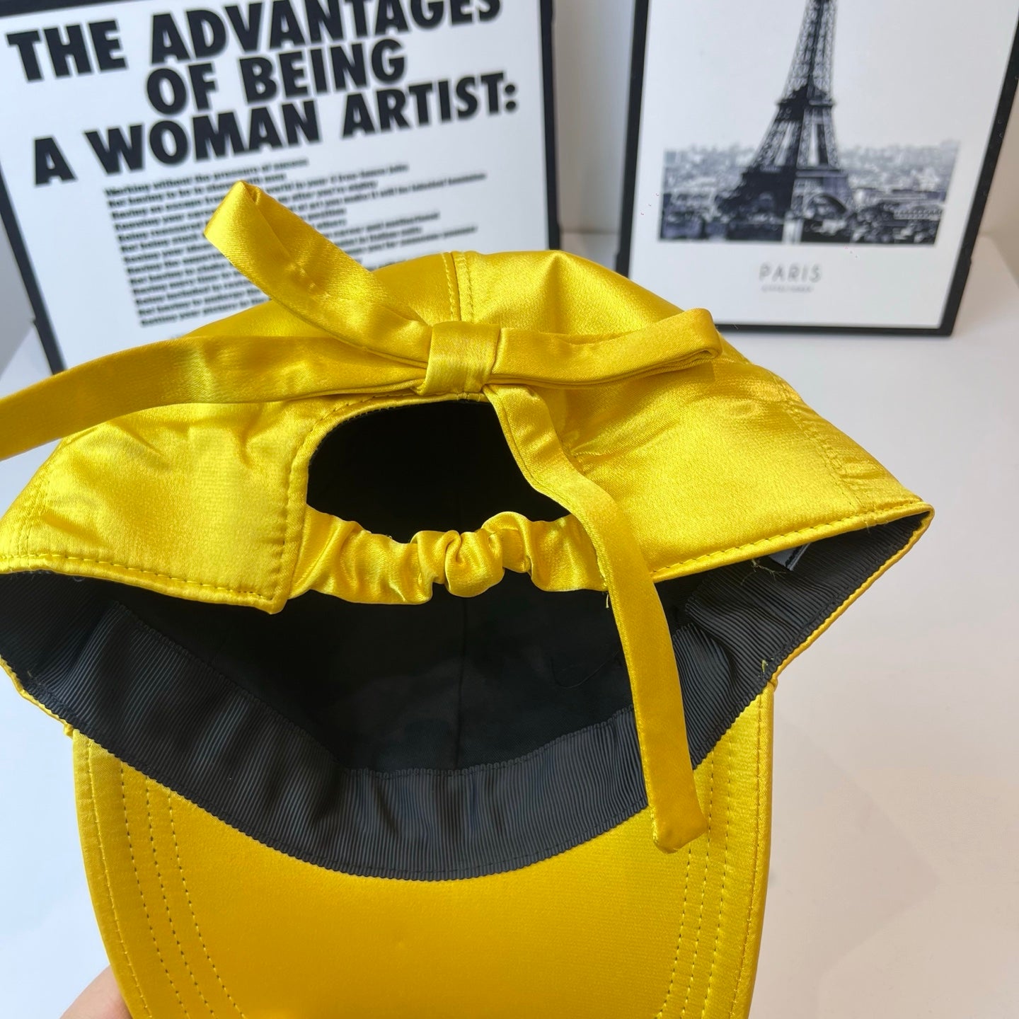 Prada yellow satin cap with open side showing black interior lining