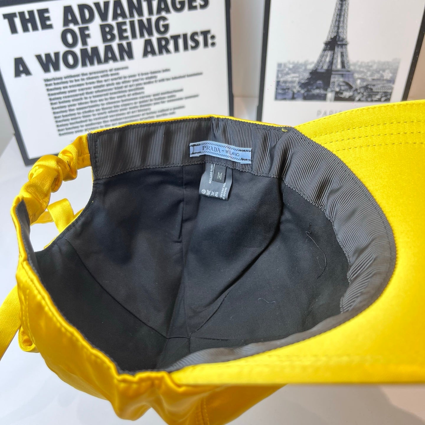 Prada cap interior view with black lining and size label on the band