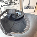 Prada cap interior view with striped lining and size label near the top.