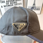 Navy Prada cap with embroidered triangular PRADA label and blue contrast brim edge.