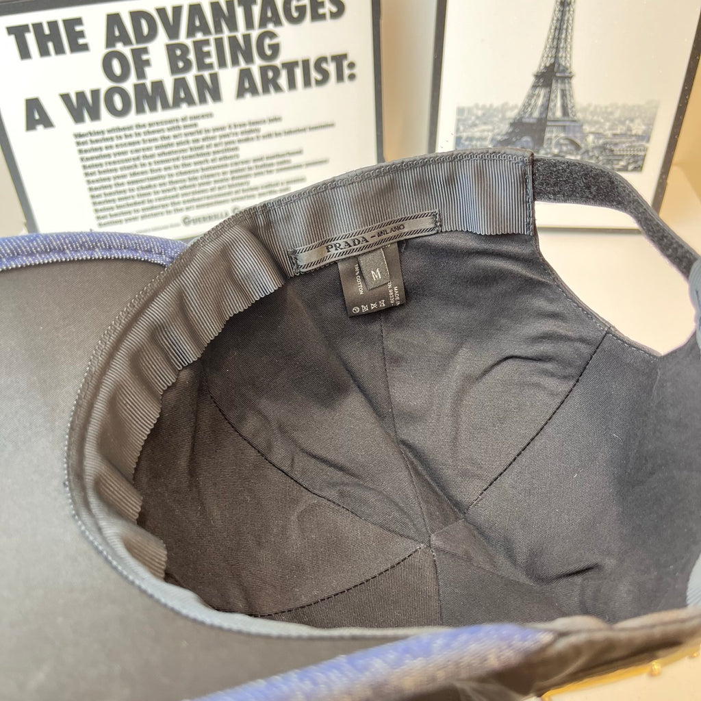 Navy Prada cap interior with size label and inner lining, curved brim opening.