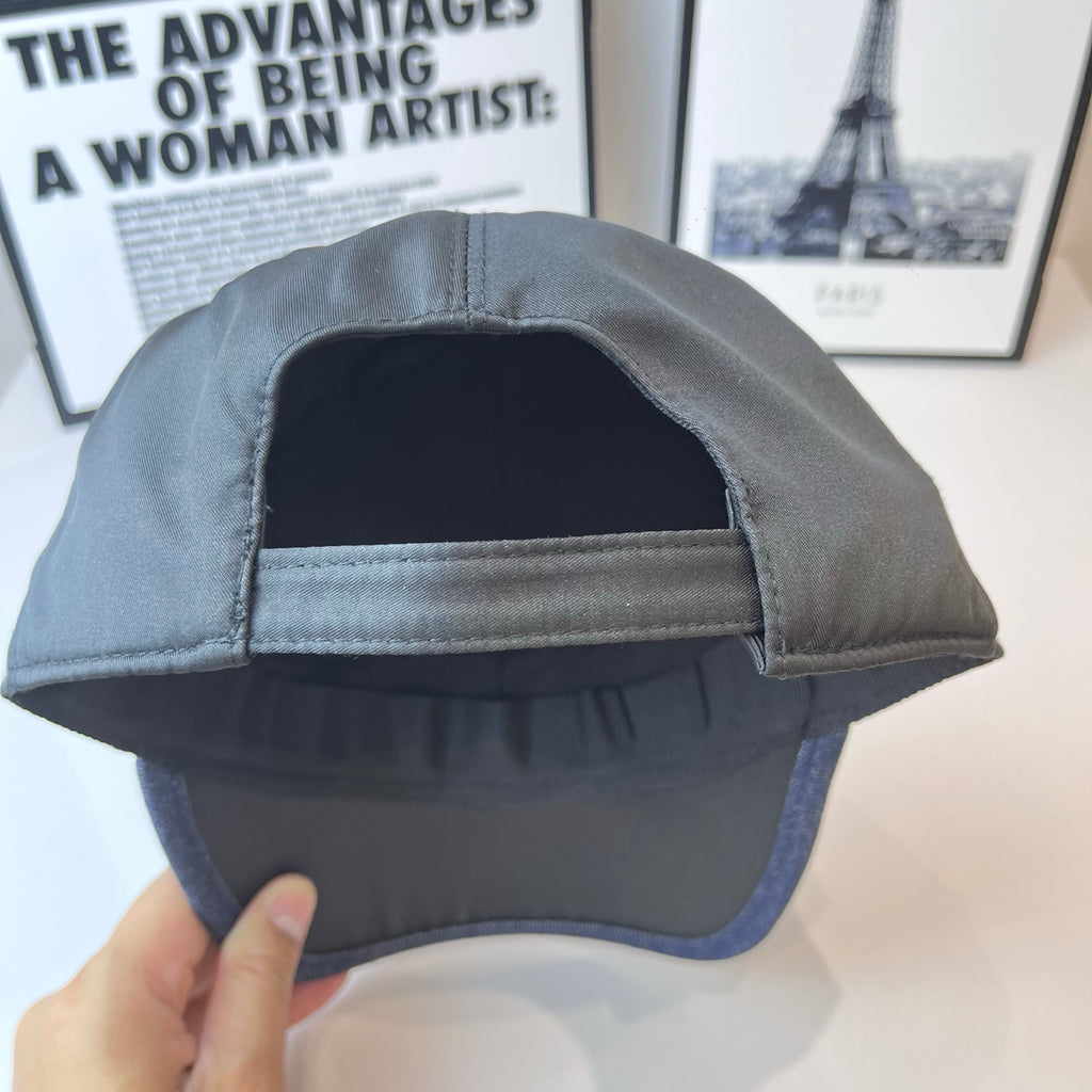 Navy Prada baseball cap interior with sewn brim lining and curved opening.
