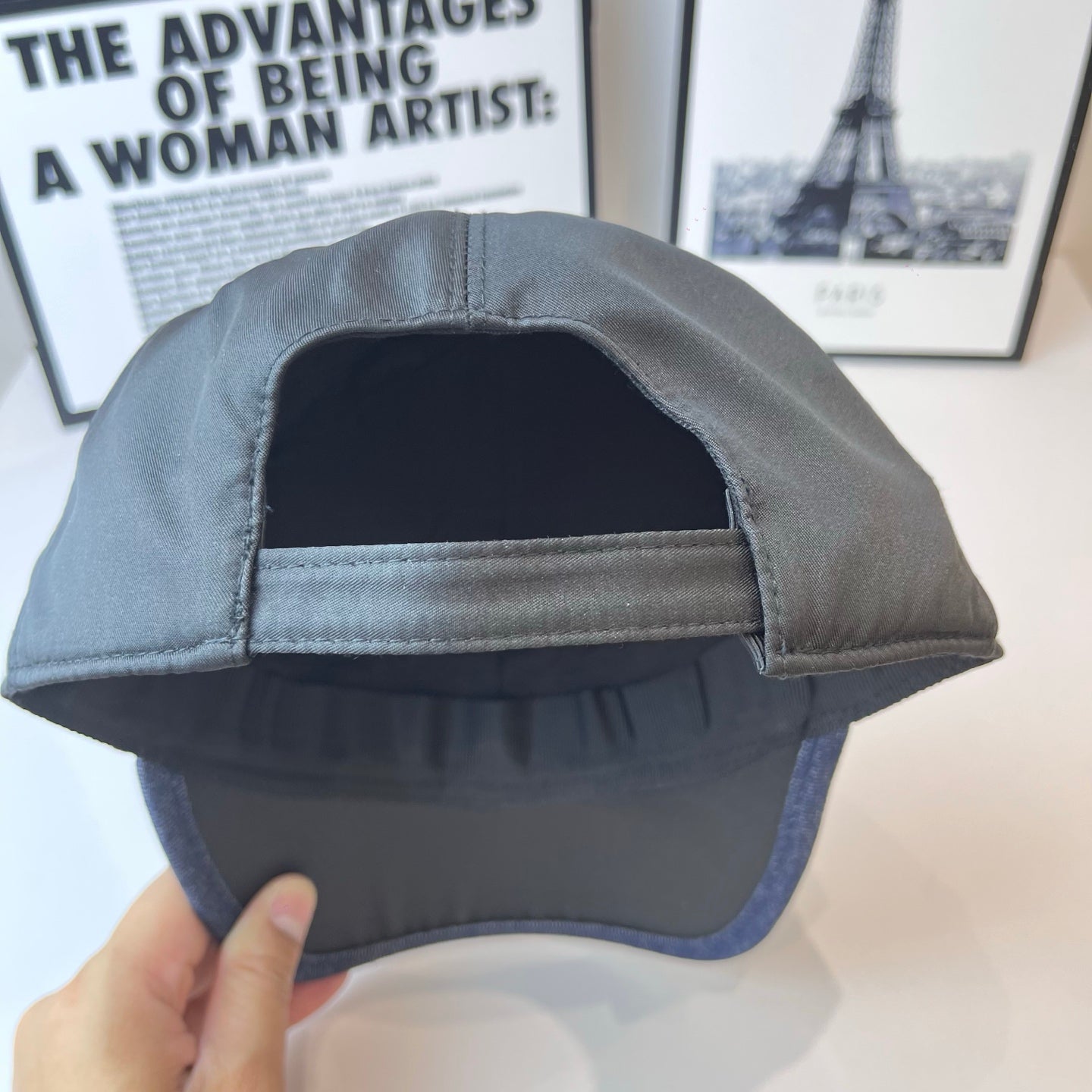 Navy Prada baseball cap interior with sewn brim lining and curved opening.
