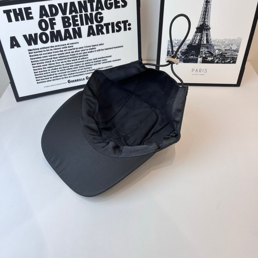 Dark baseball cap with gathered interior crown and curved brim, no logo visible.