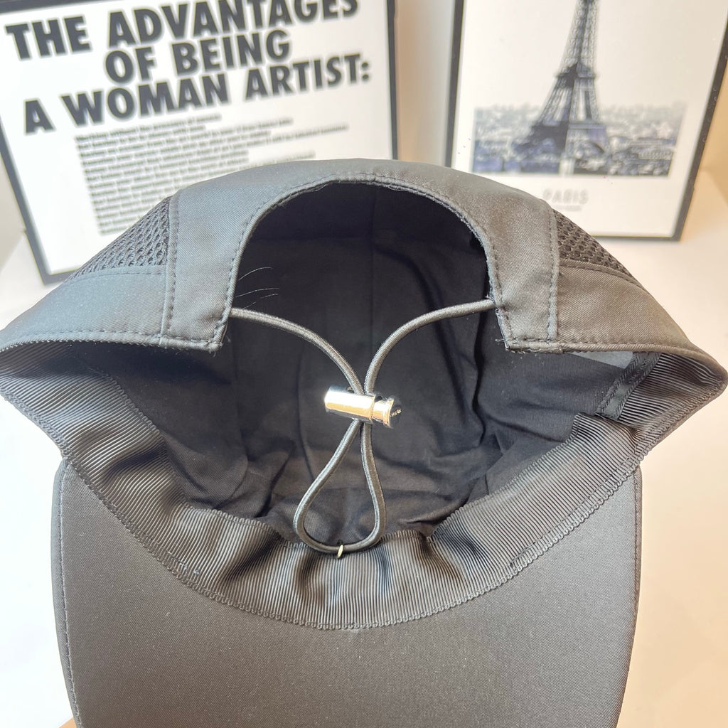 Baseball cap interior with metal D-ring and adjustable strap, dark fabric.