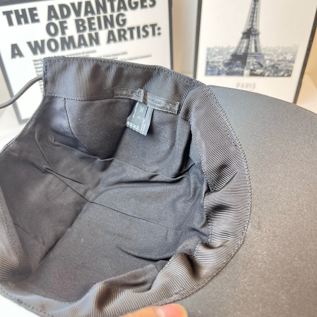 Baseball cap interior lining with size label and stitched panels, dark cap.