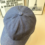 Prada denim cap in dark blue, back view with stitched seams and top button.