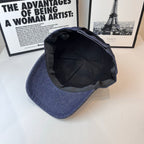 Prada denim cap interior view, black lining and curved brim opening.