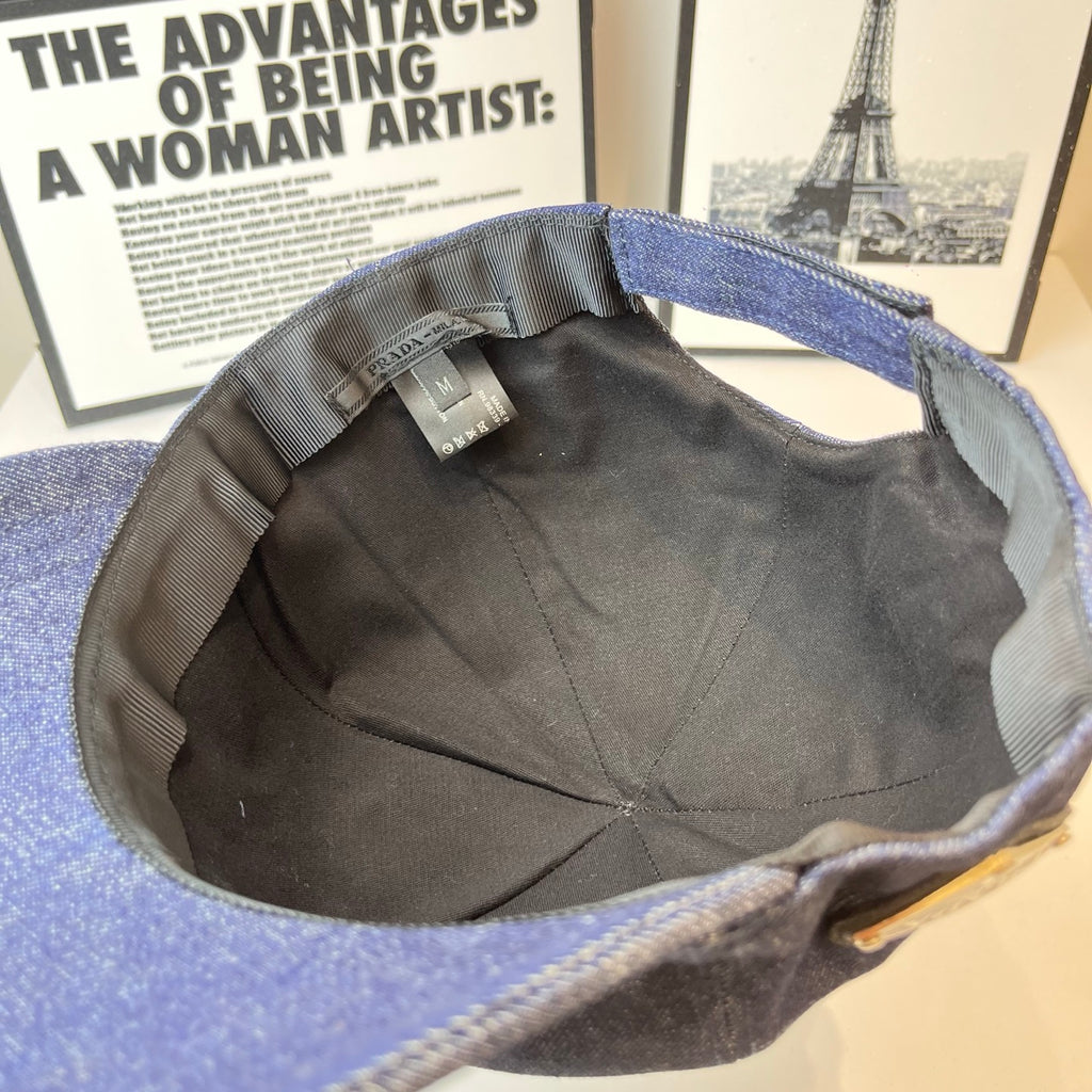 Prada denim cap interior with black lining and small fabric tag near crown.