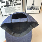 Prada denim cap interior view, black lining with front panel stitching.