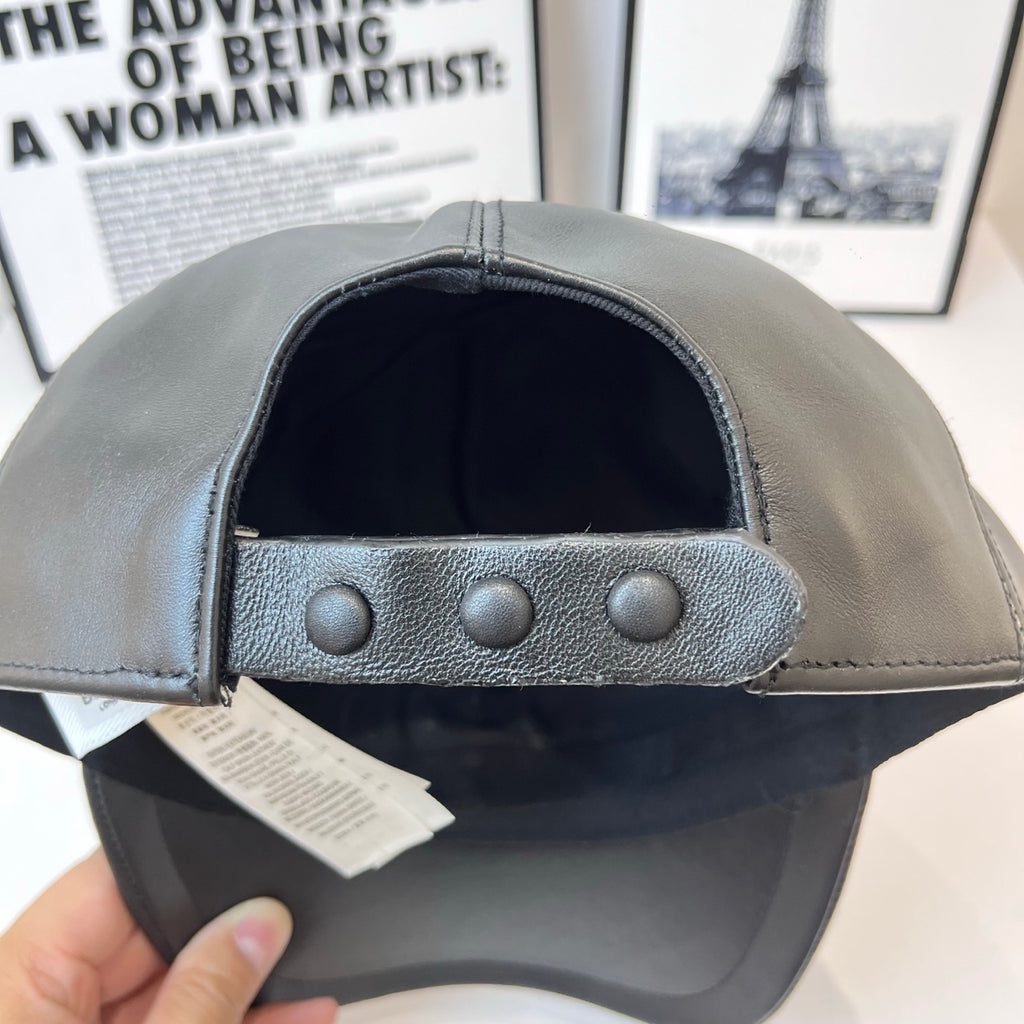 Dark leather baseball cap, inner band with three metal studs and snap closure
