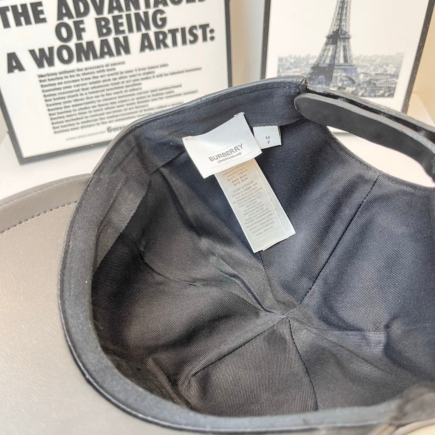 Leather baseball cap interior with dark lining and Burberry product tags