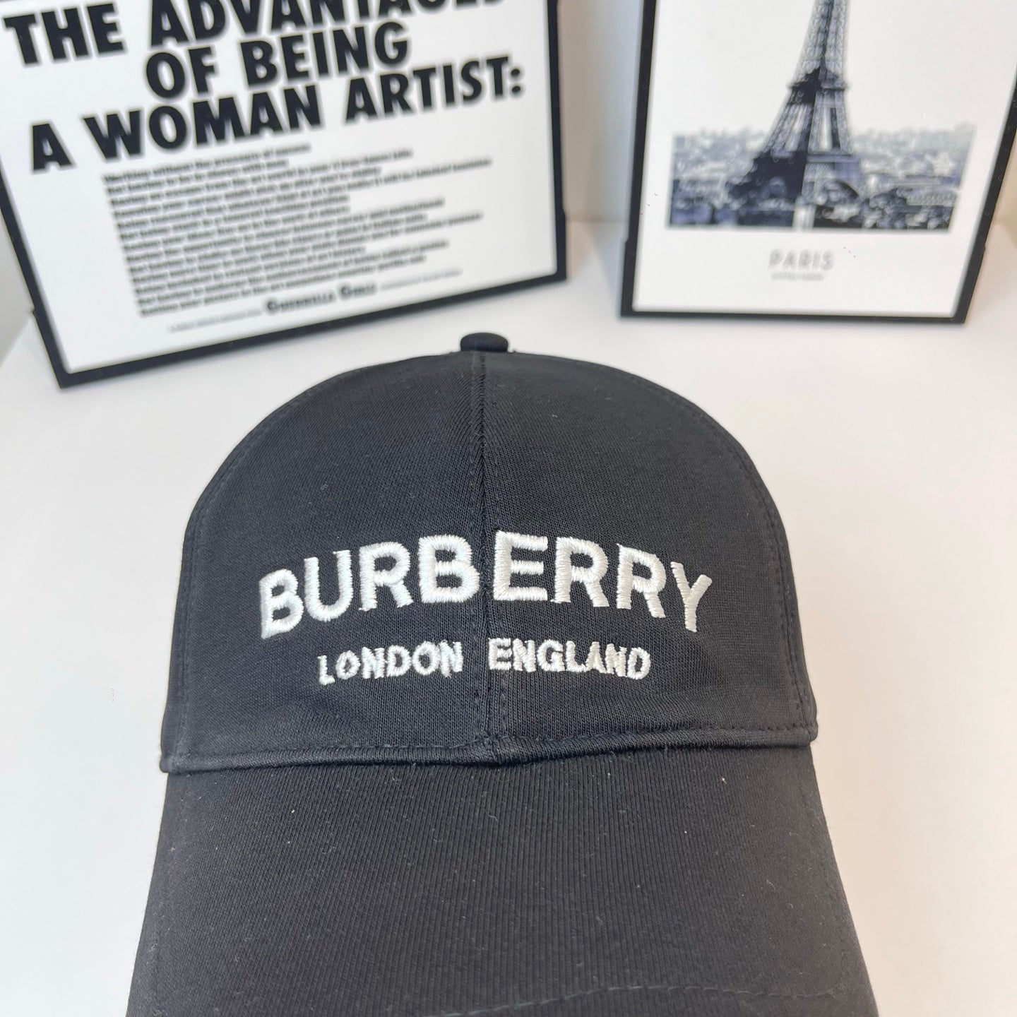 Black Burberry baseball cap close view of front logo and "LONDON ENGLAND".