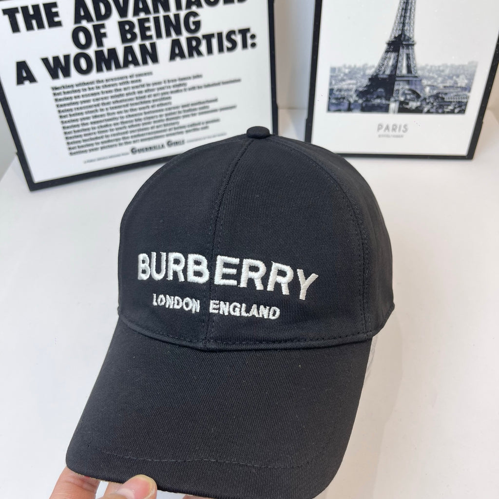 Black Burberry cap with front embroidered "BURBERRY" and "LONDON ENGLAND".