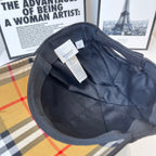 Black Burberry cap interior with hanging size tag and quilted lining at crown.