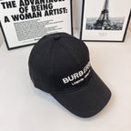Black Burberry baseball cap angled view with embroidered "BURBERRY" and "LONDON ENGLAND".