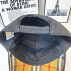 Black Burberry cap interior with curved brim and stitched seam around the opening.