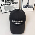 Black Burberry baseball cap with front logo and "LONDON ENGLAND" text.