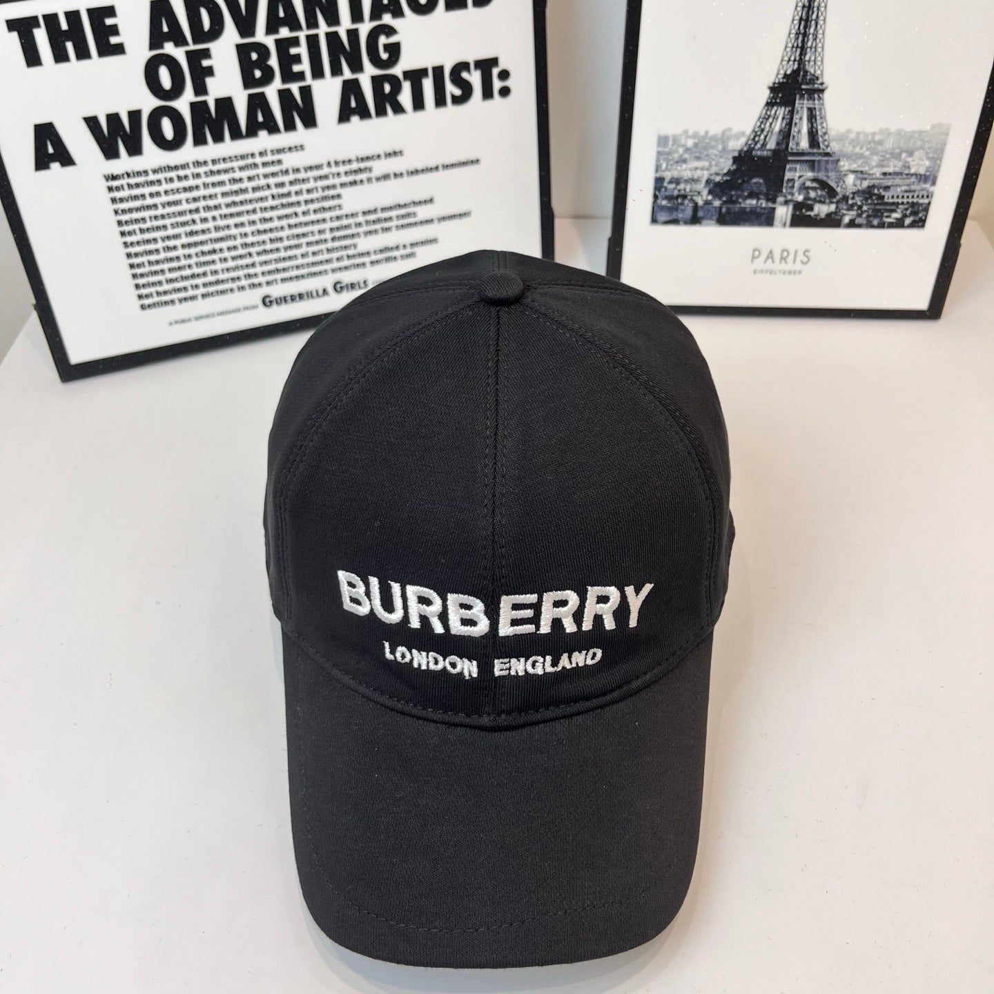 Black Burberry baseball cap with front logo and "LONDON ENGLAND" text.
