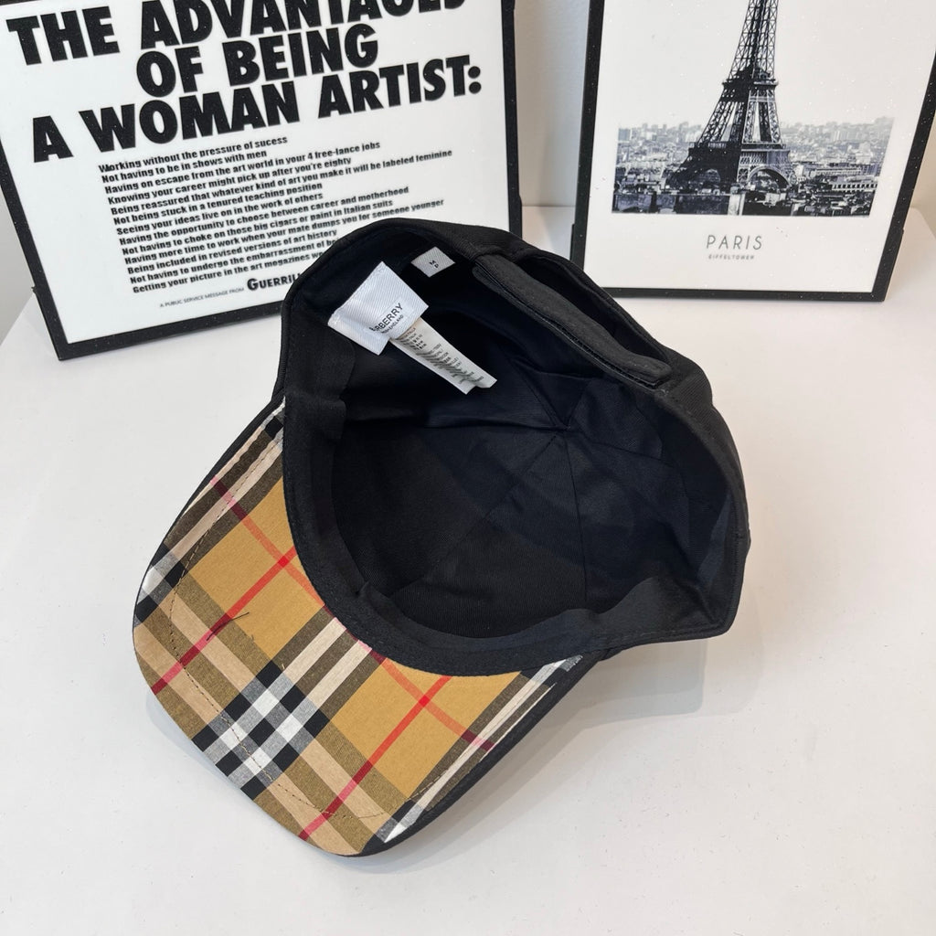 Black Burberry cap interior and underside view with inner label and quilted lining.