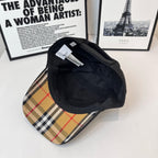 Black Burberry cap interior and underside view with inner label and quilted lining.