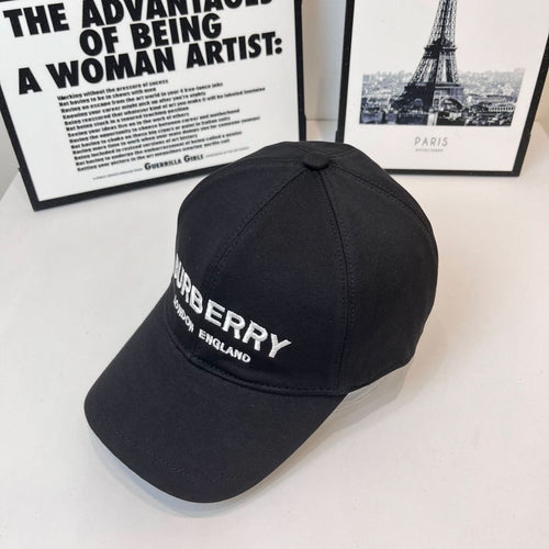Black Burberry cap with side embroidered logo and "LONDON ENGLAND" text.