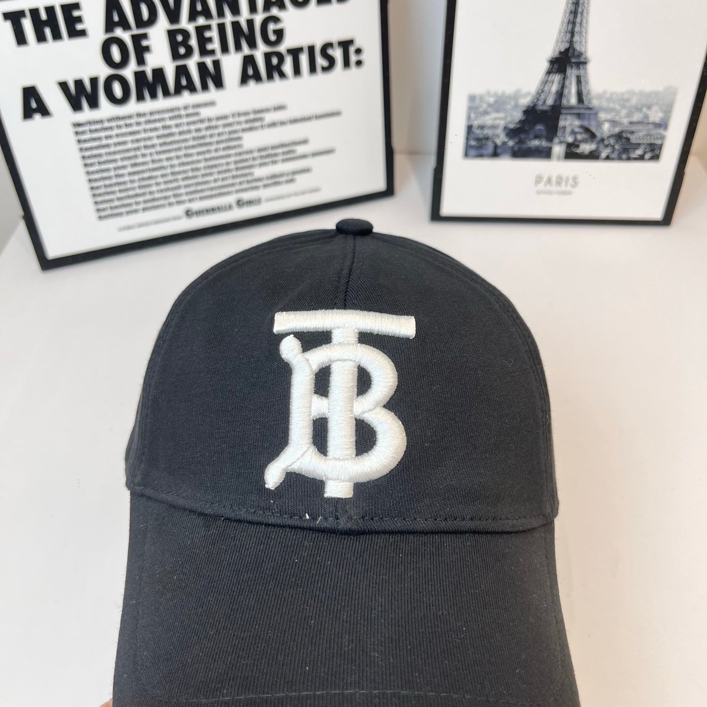 Black Burberry cap close-up front with large white TB logo