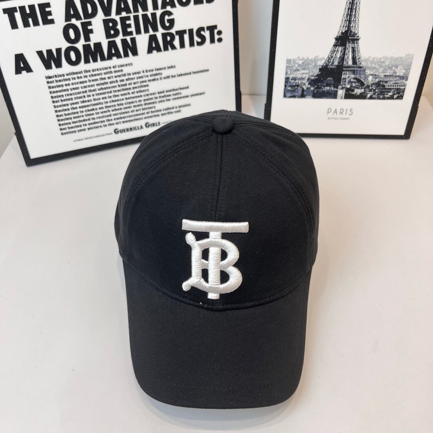 Black Burberry cap with white TB monogram on the front