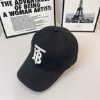 Dark Burberry cap angled view with white TB logo patch
