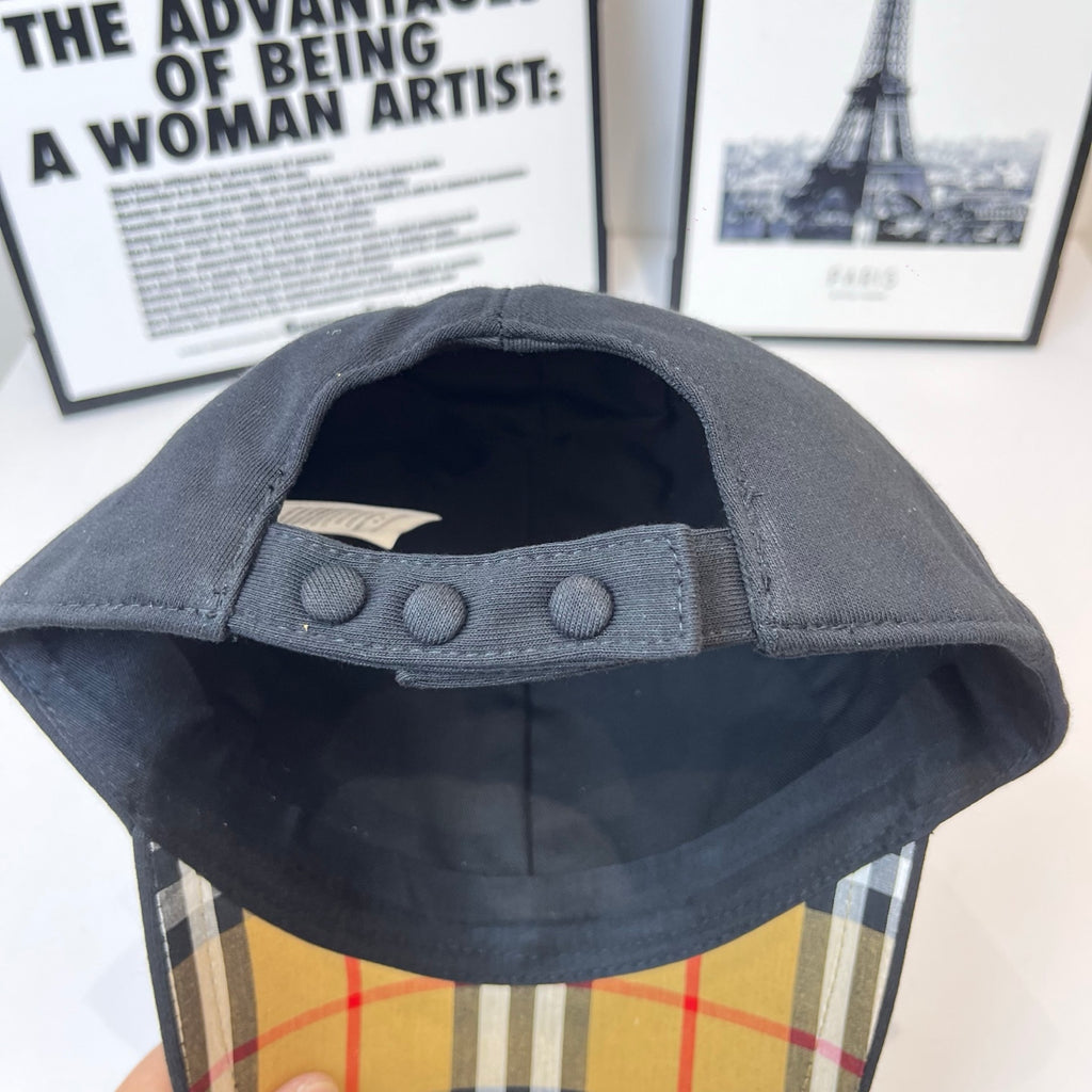 Dark Burberry cap interior with buttoned adjustable strap