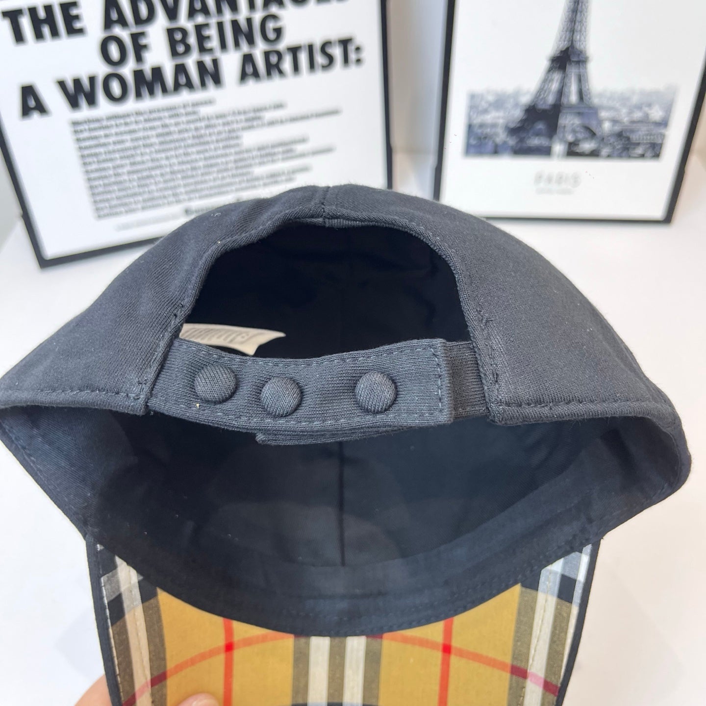 Dark Burberry cap interior with buttoned adjustable strap