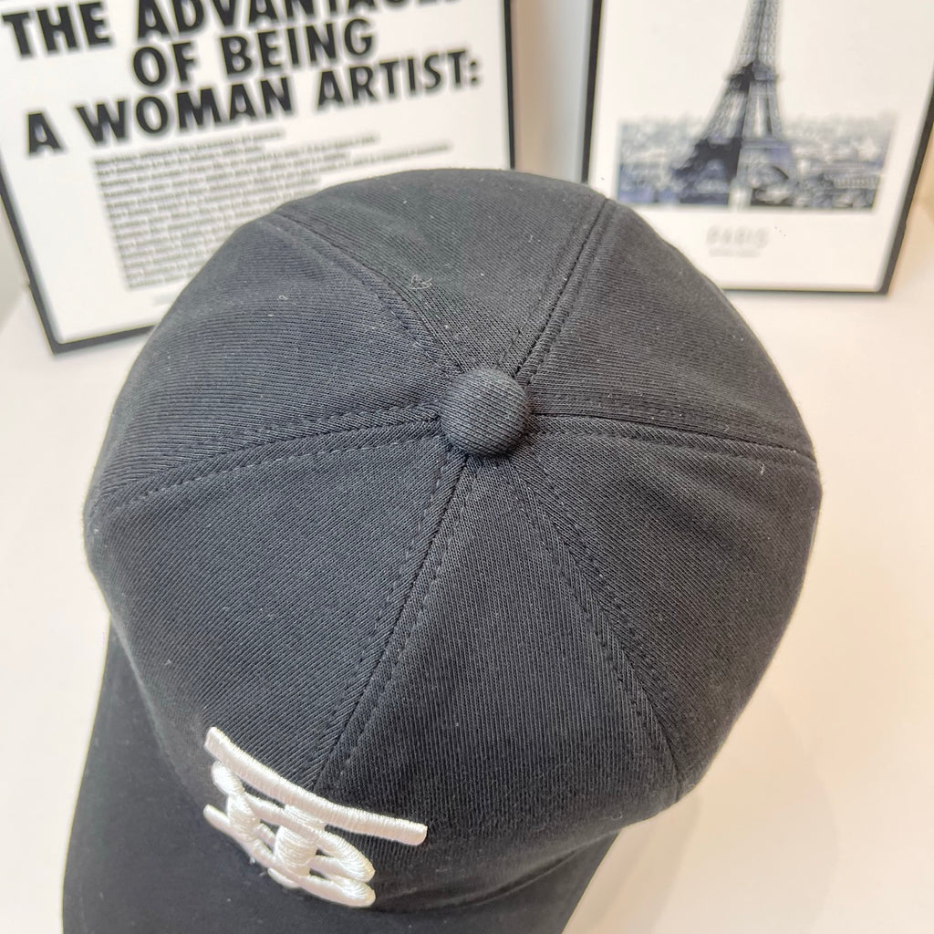 Dark Burberry cap back view with small white TB logo