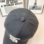 Dark Burberry cap back view with small white TB logo