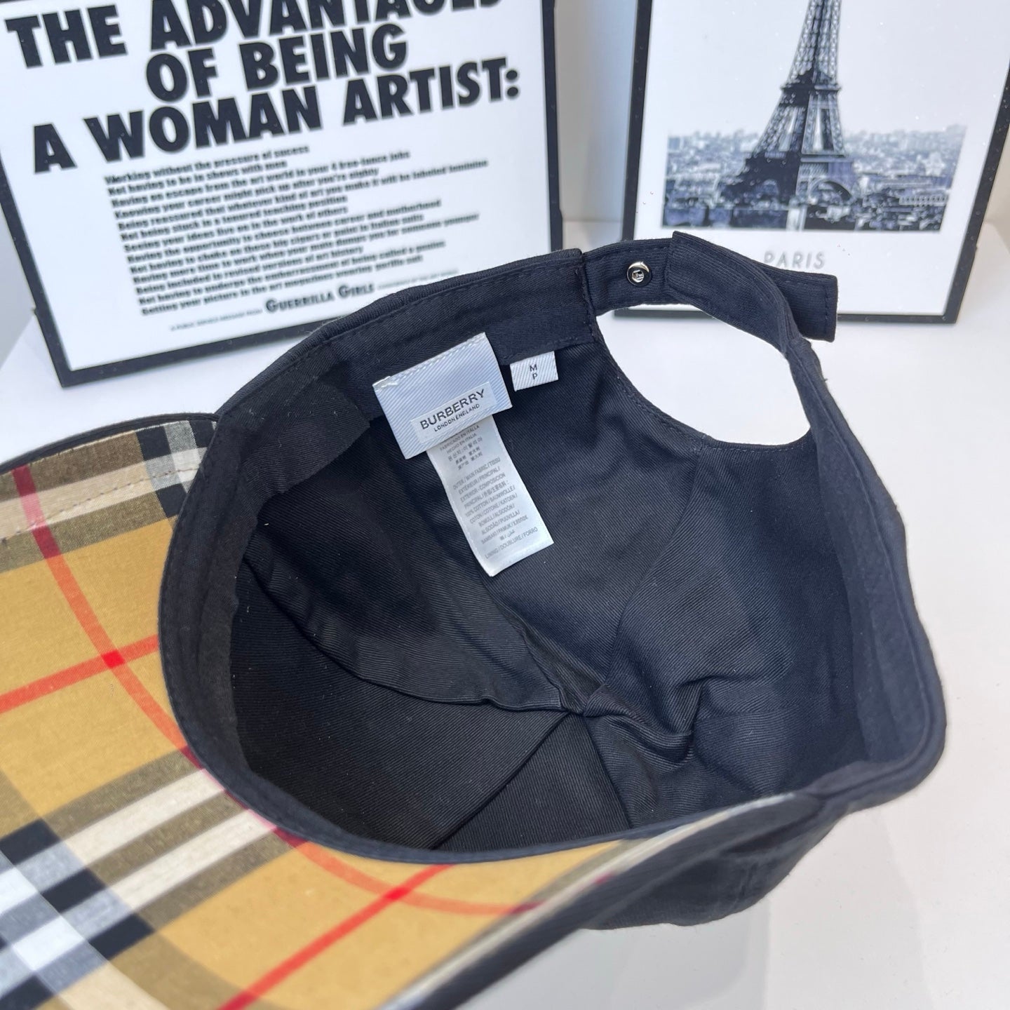 Dark Burberry cap inside view with hanging label and inner brim