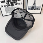 Black Burberry cap with mesh back, curved brim, and side tag attached