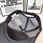 Black Burberry mesh cap with inside view and fabric tag with snap button