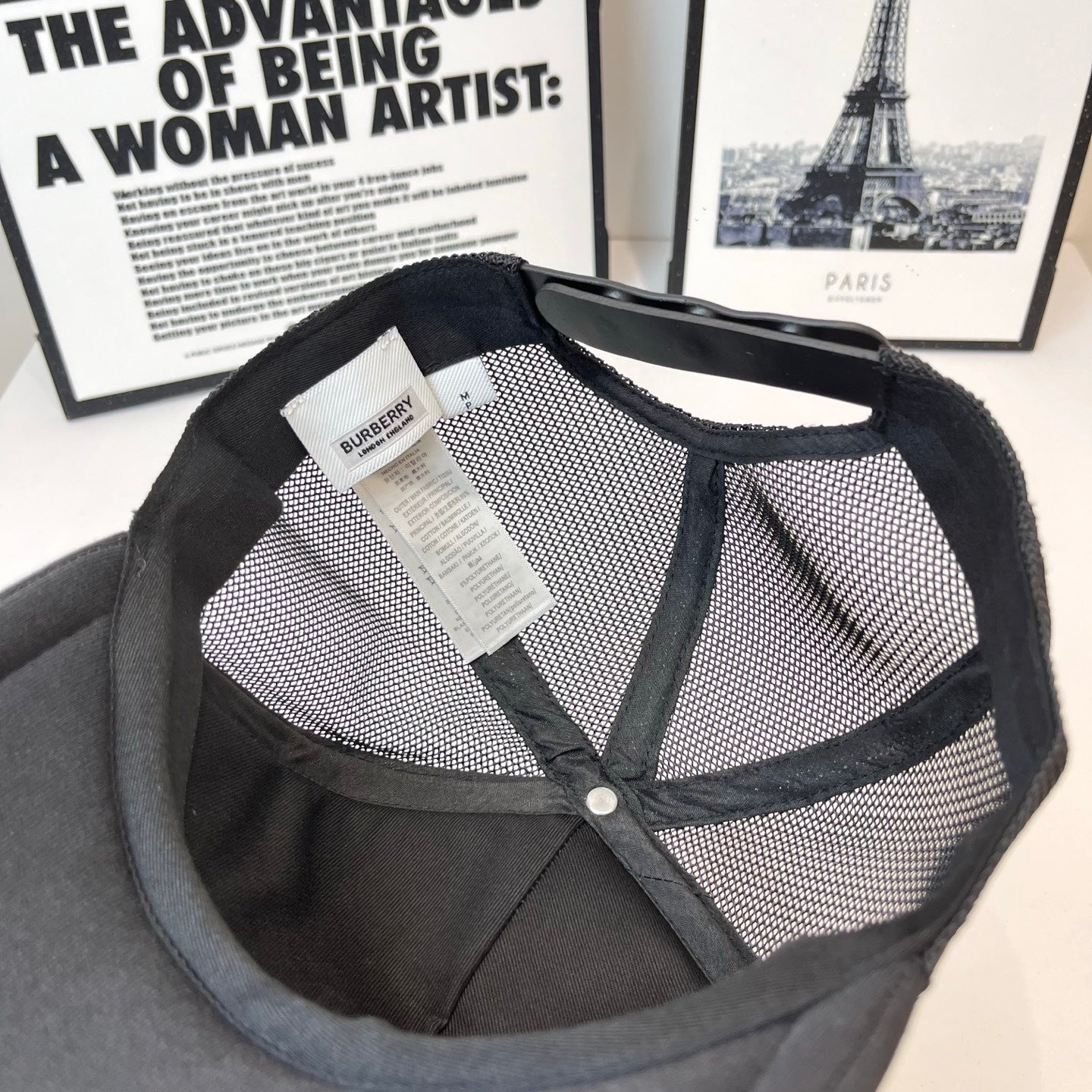 Black Burberry mesh cap with inside view and fabric tag with snap button