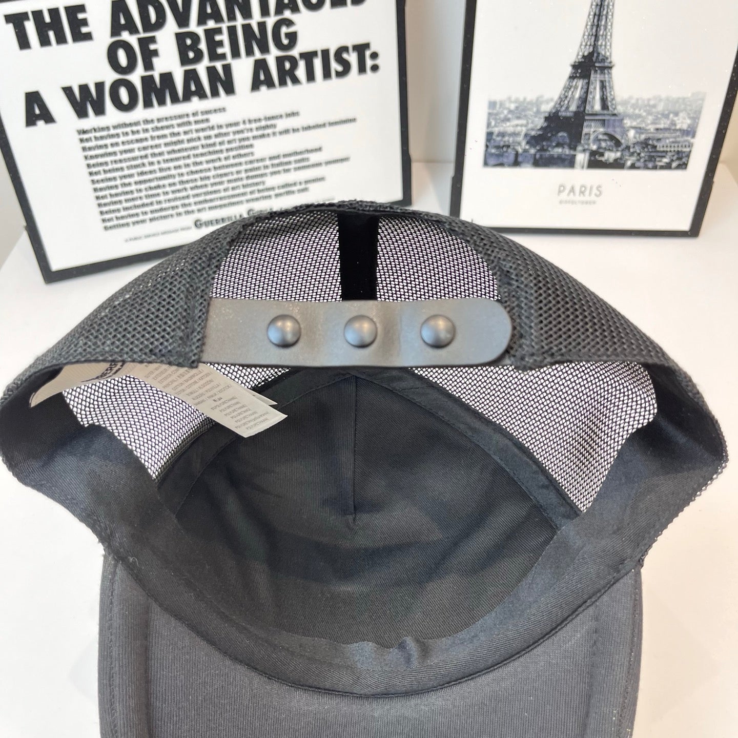 Black Burberry cap with mesh back and adjustable metal snap strap