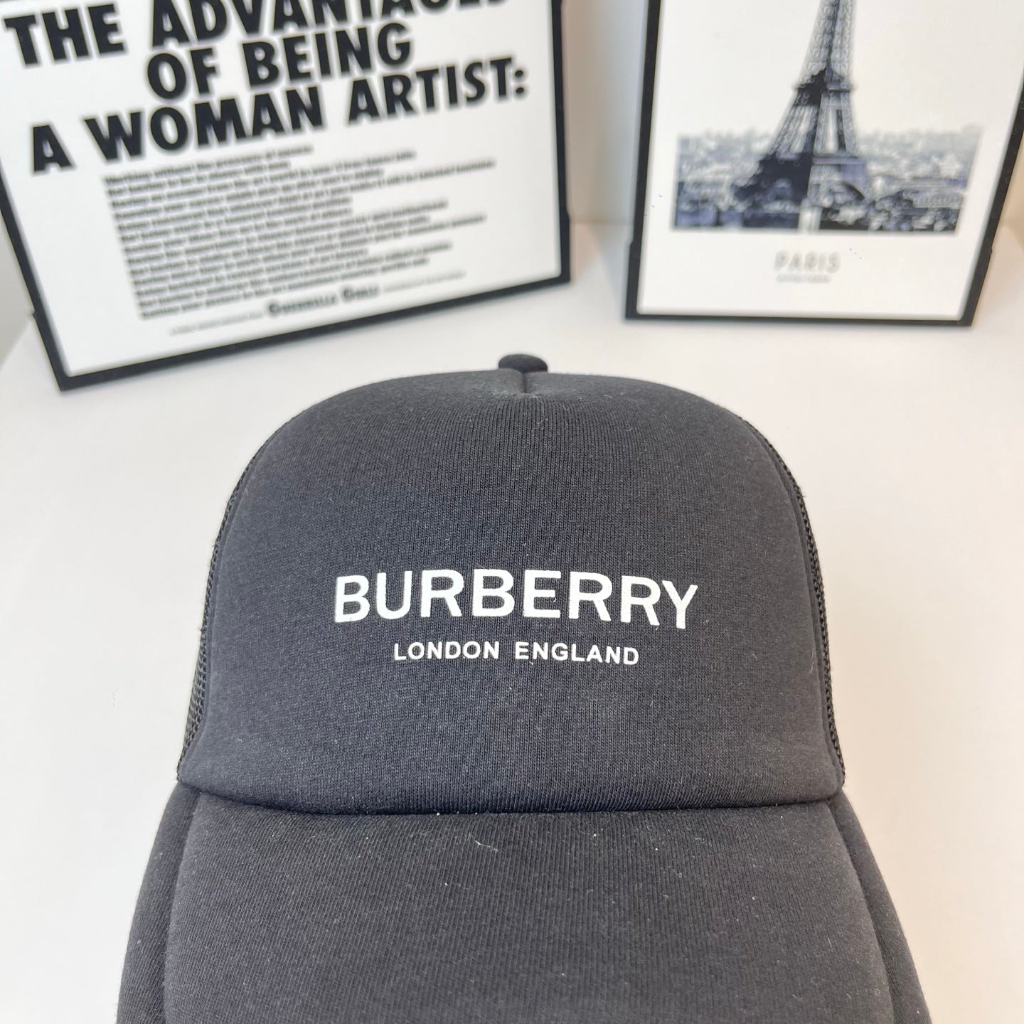 Black Burberry cap with centered front logo and small top button