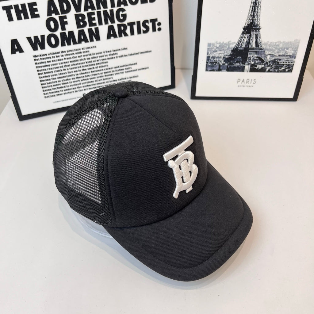 Black baseball cap with side mesh panels and white embroidered monogram logo