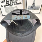 Black and gray mesh cap with buttoned crown and decorative strap detail