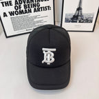 Black baseball cap with white embroidered monogram logo on front and curved brim