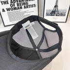 Black mesh-back cap interior with brand tag and buttoned opening near crown