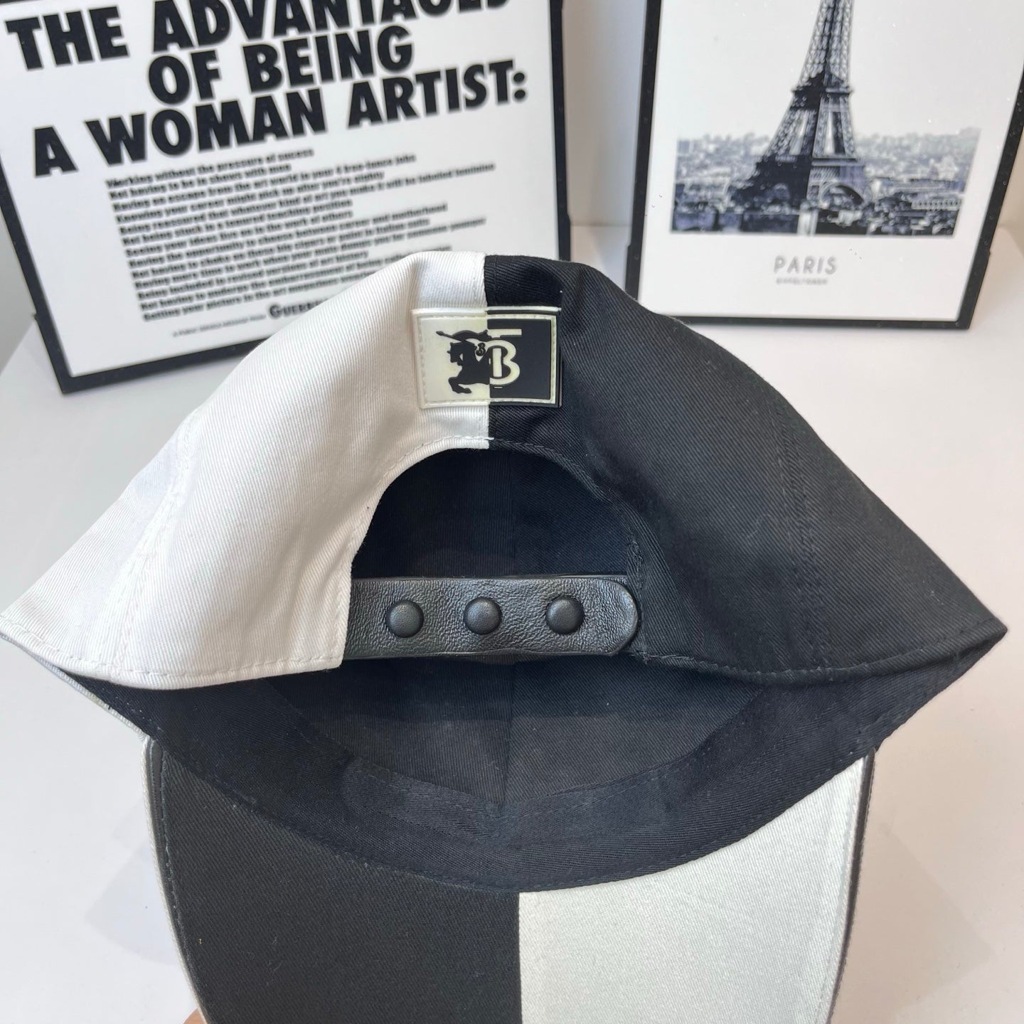 Burberry cap with adjustable snap strap and TB label patch on the interior