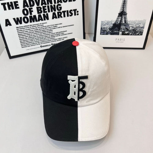 Two-tone Burberry cap with black crown, white brim, TB logo patch, and red button