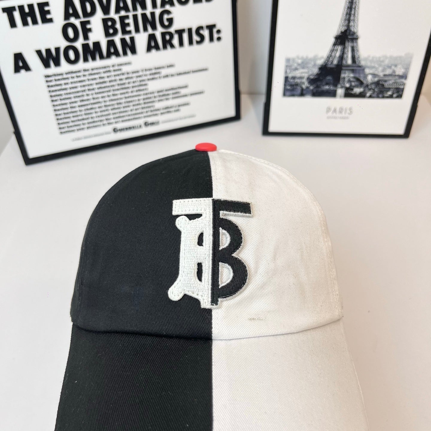 Two-tone Burberry cap with TB logo centered on front and red button on crown