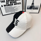Two-tone Burberry cap with black side, white front, TB monogram and red top button