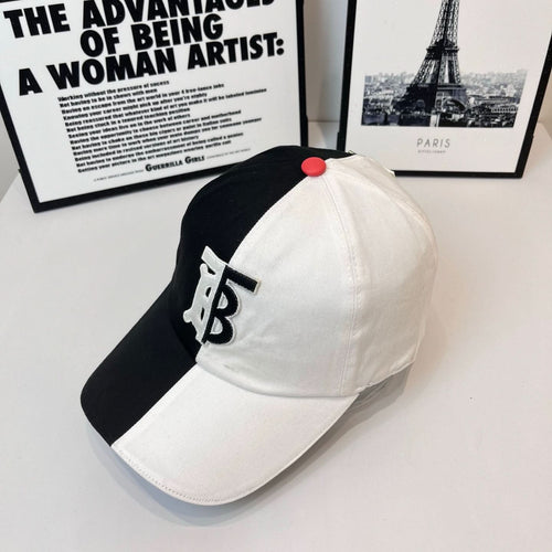 Two-tone Burberry cap with black side, white front, TB monogram and red top button